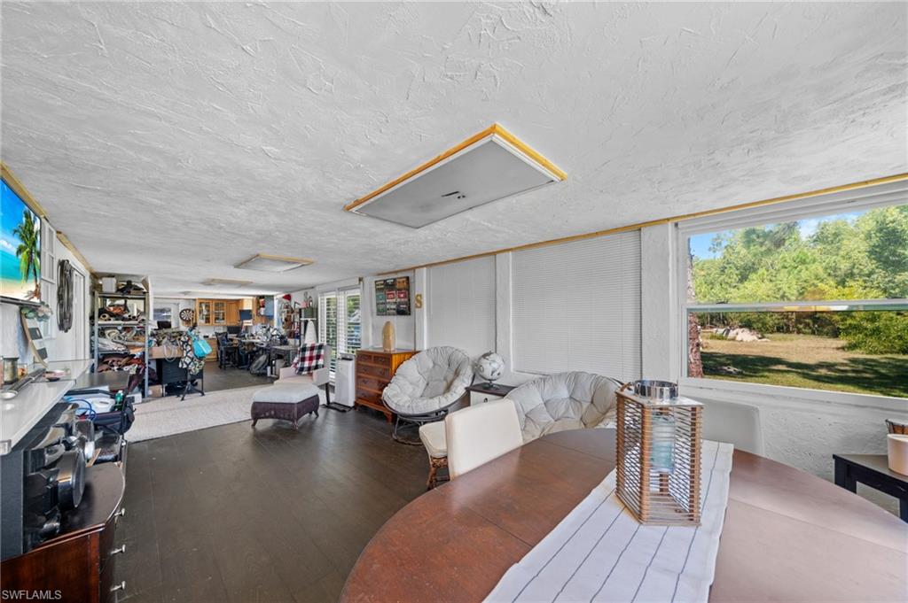 Dining area with wood finished floors and a textured ceiling