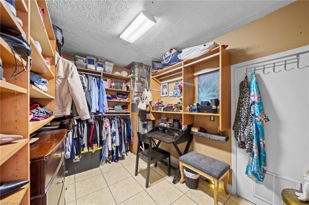 Walk in closet featuring light tile patterned floors