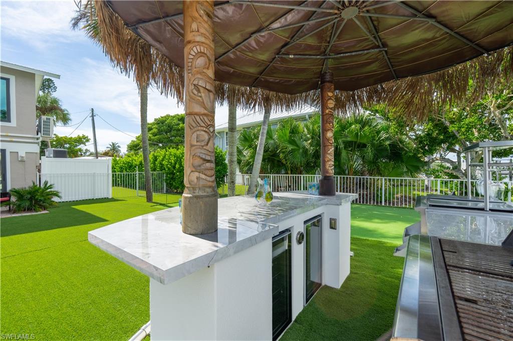 Fenced backyard with area for grilling, a patio area - Virtually Edited Image