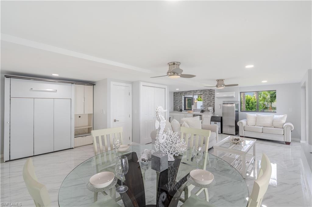 Dining room featuring light tile finish flooring, recessed lighting, and a ceiling fan - Virtually Edited Image