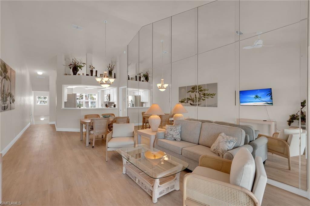 Living room featuring light wood-style floors and high vaulted ceiling