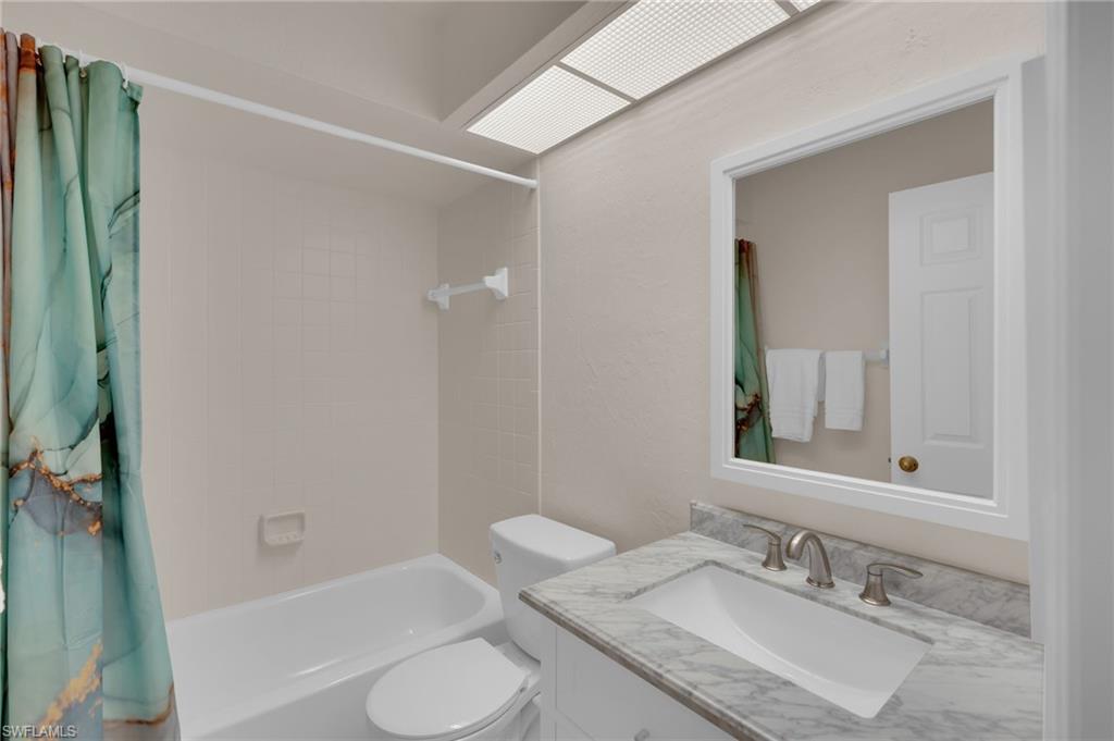 Full bath with vanity and shower / bath combo with shower curtain