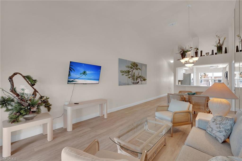 Living room featuring wood finished floors and a towering ceiling