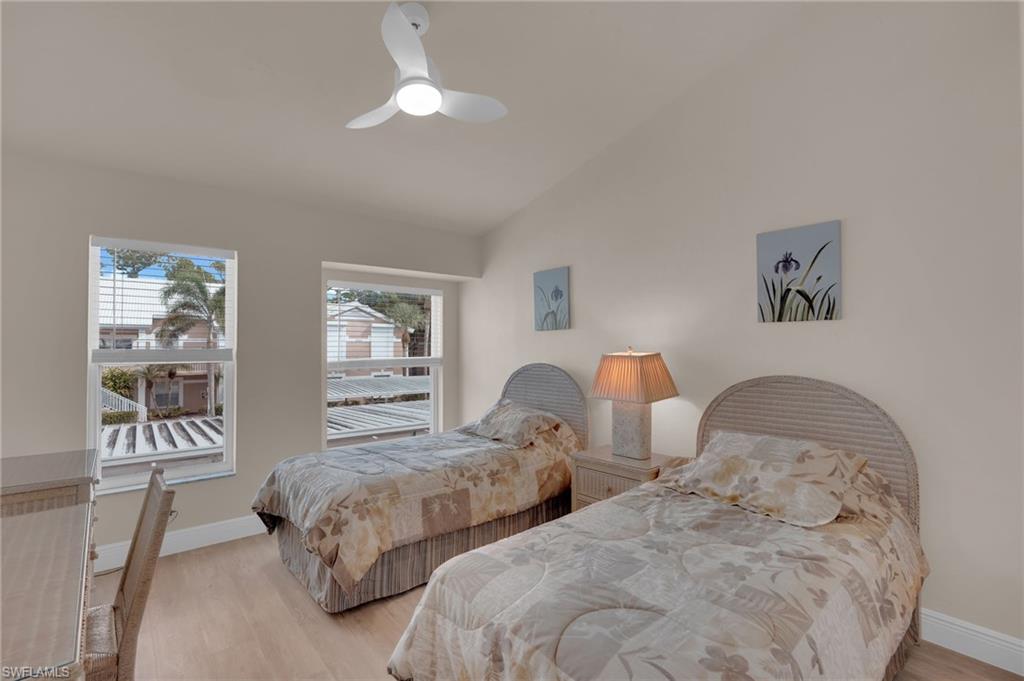 Bedroom featuring vaulted ceiling, light wood-type flooring, and ceiling fan
