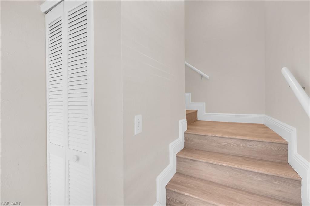 Entryway with Stairs featuring wood finished floors and baseboards