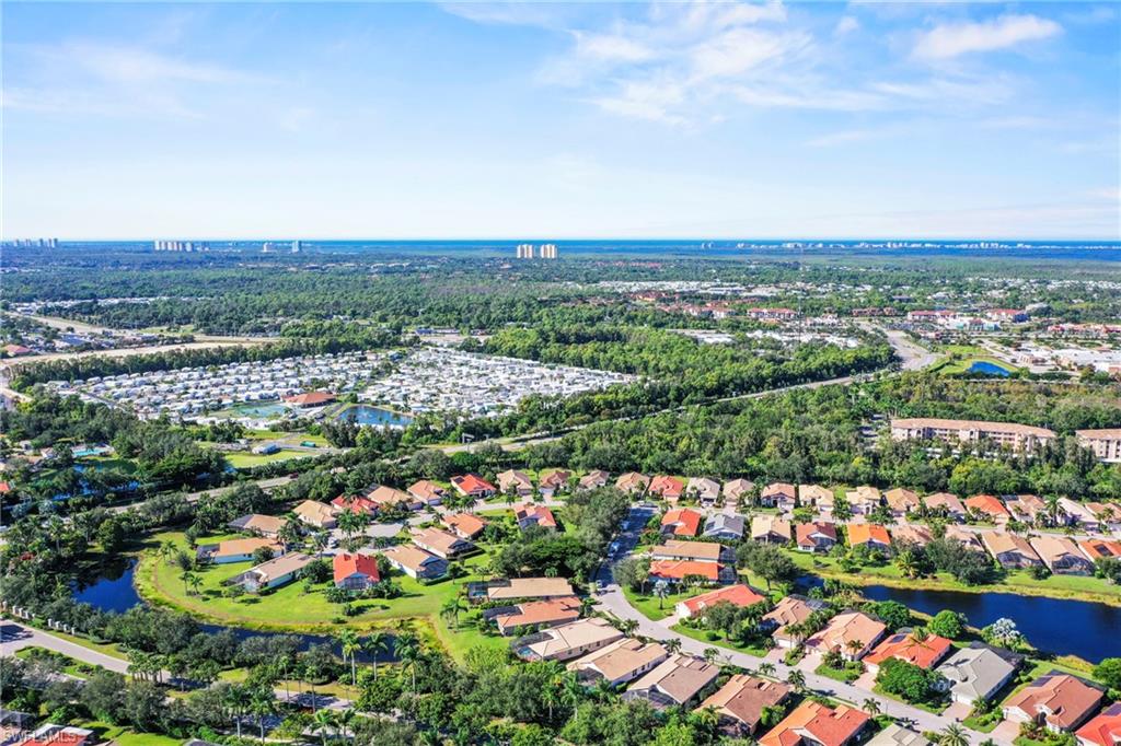 View of property location featuring a large body of water and nearby suburban area