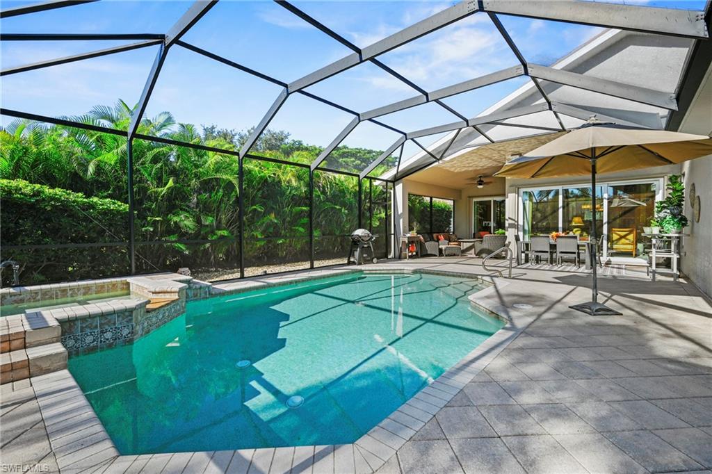 View of swimming pool with ceiling fan, a lanai, a sunroom, a patio area, and a pool with connected hot tub