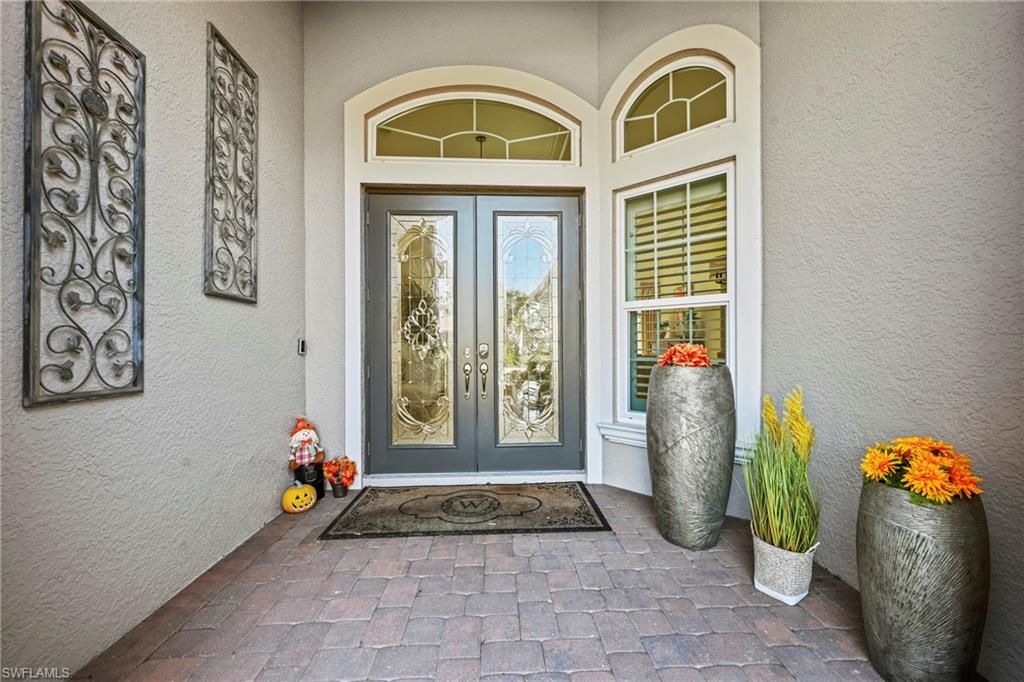 Property entrance featuring french doors and stucco siding