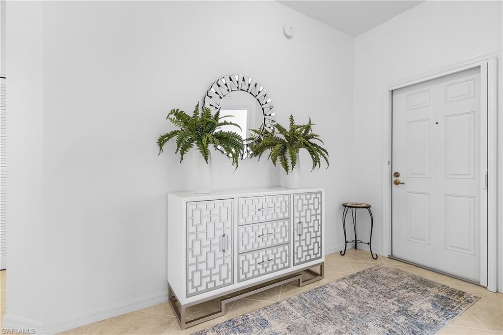 Foyer with light tile patterned floors.