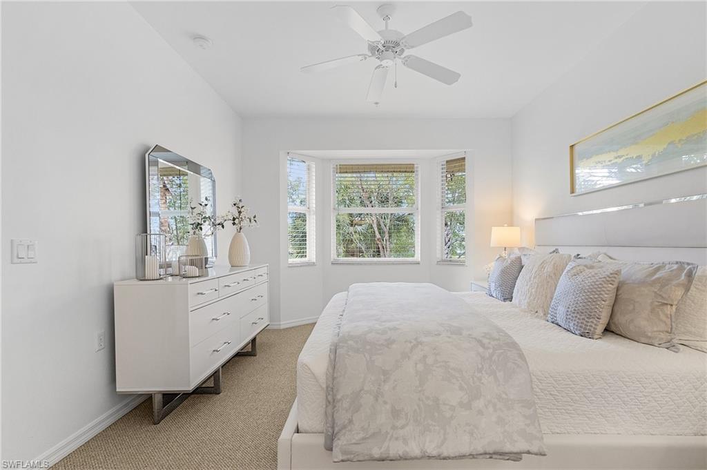 Primary bedroom faces South overlooking 4th fairway and pond with private bath and walk-in closets.
