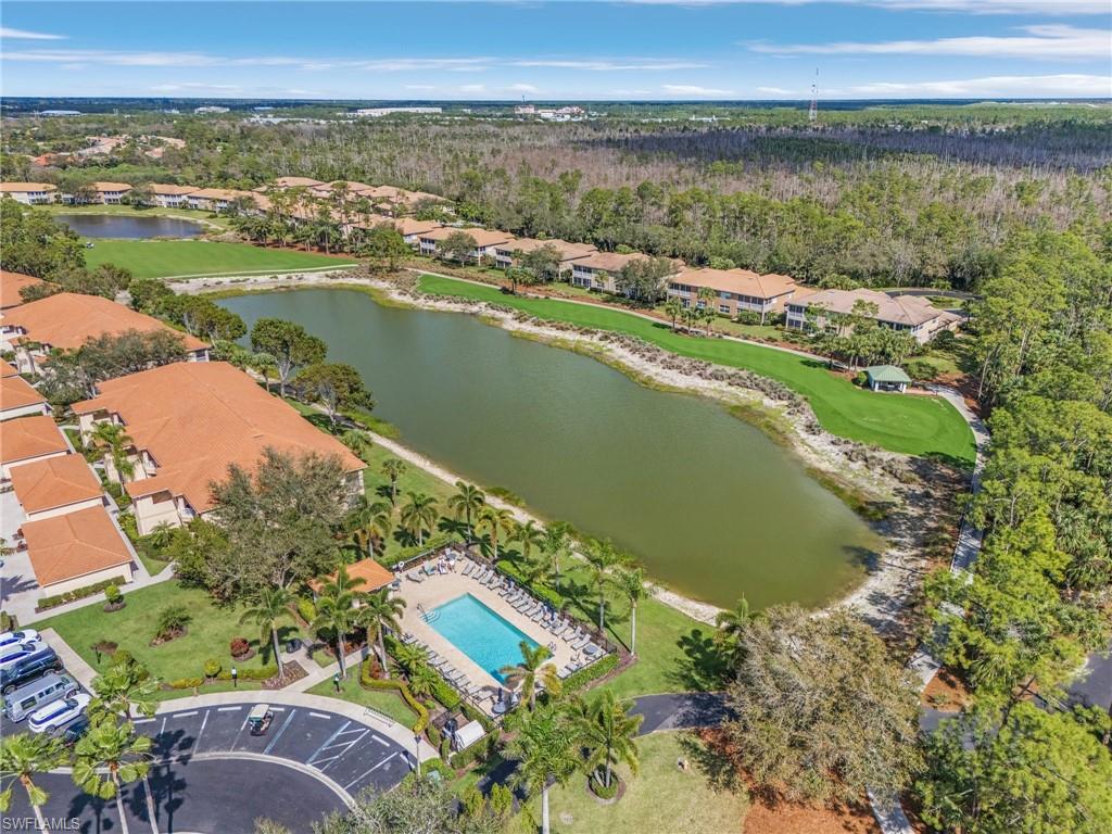 Aerial view of neighborhood pool overlooking the 6th tee boxes, fairway  and pond.