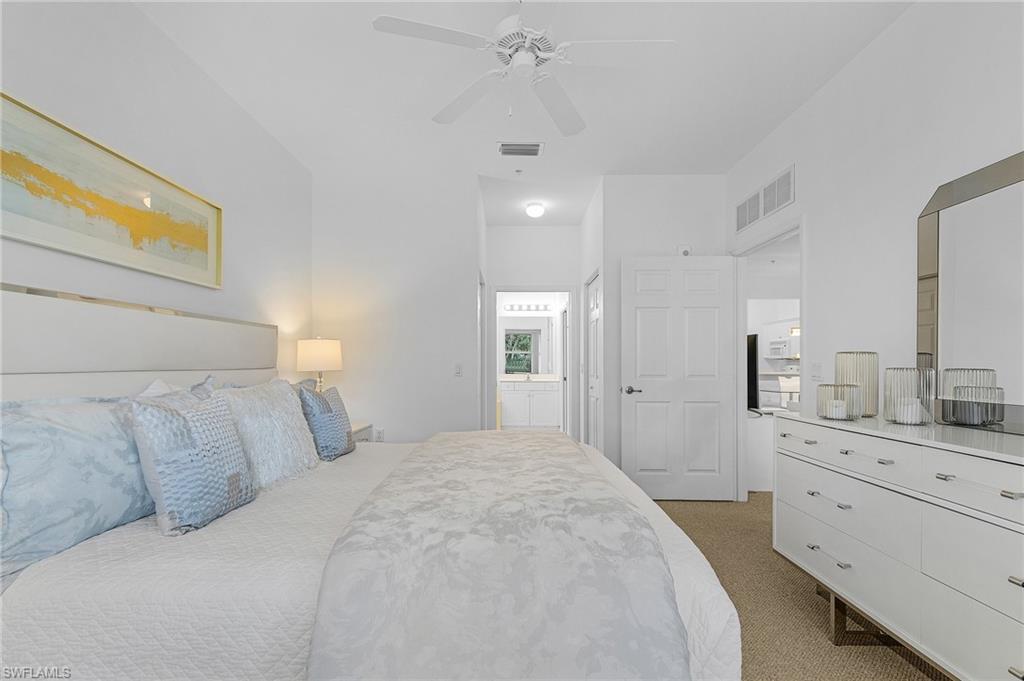 Primary bedroom faces South overlooking 4th fairway and pond with private bath and walk-in closets.