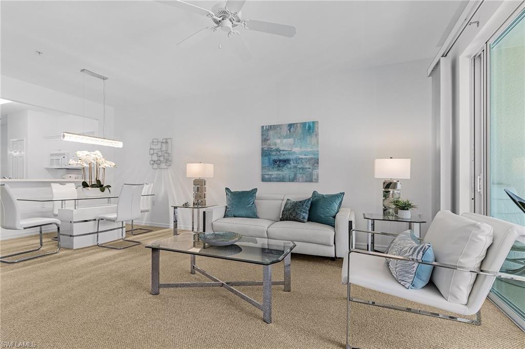 Spacious great room open to dining area and sun-filled southern facing lanai overlooking the 4th fairway and pond.
