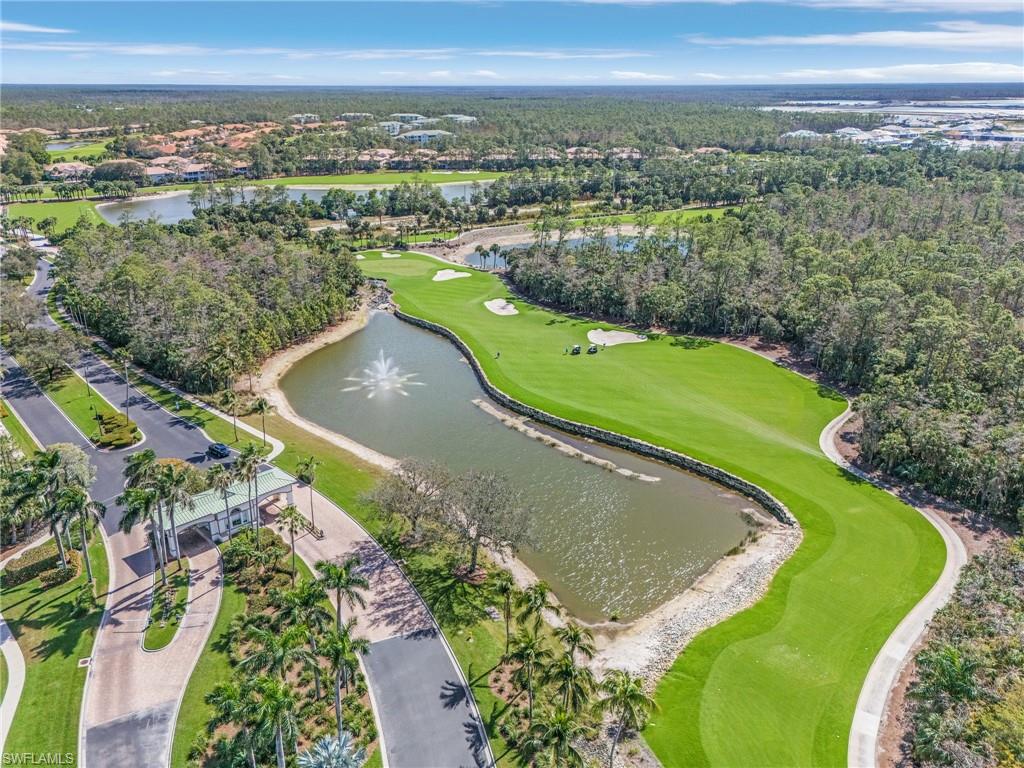 Aerial view of Forest Glen gated front entrance and the 13th fairway and pond.