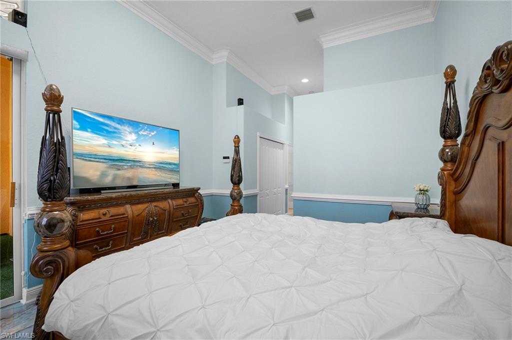 Bedroom with crown molding, a closet, and recessed lighting