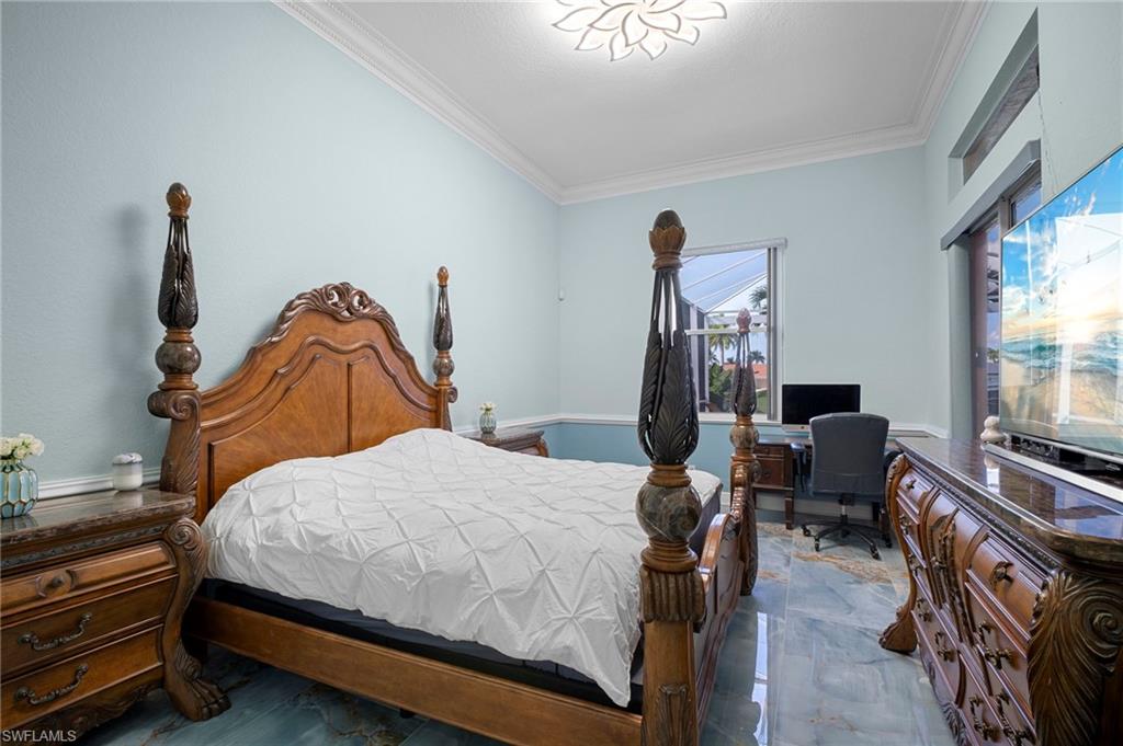 Bedroom with crown molding and a desk