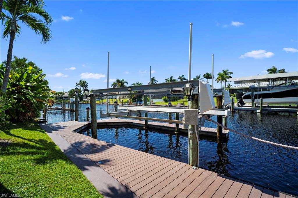 Dock with boat lift and a water view