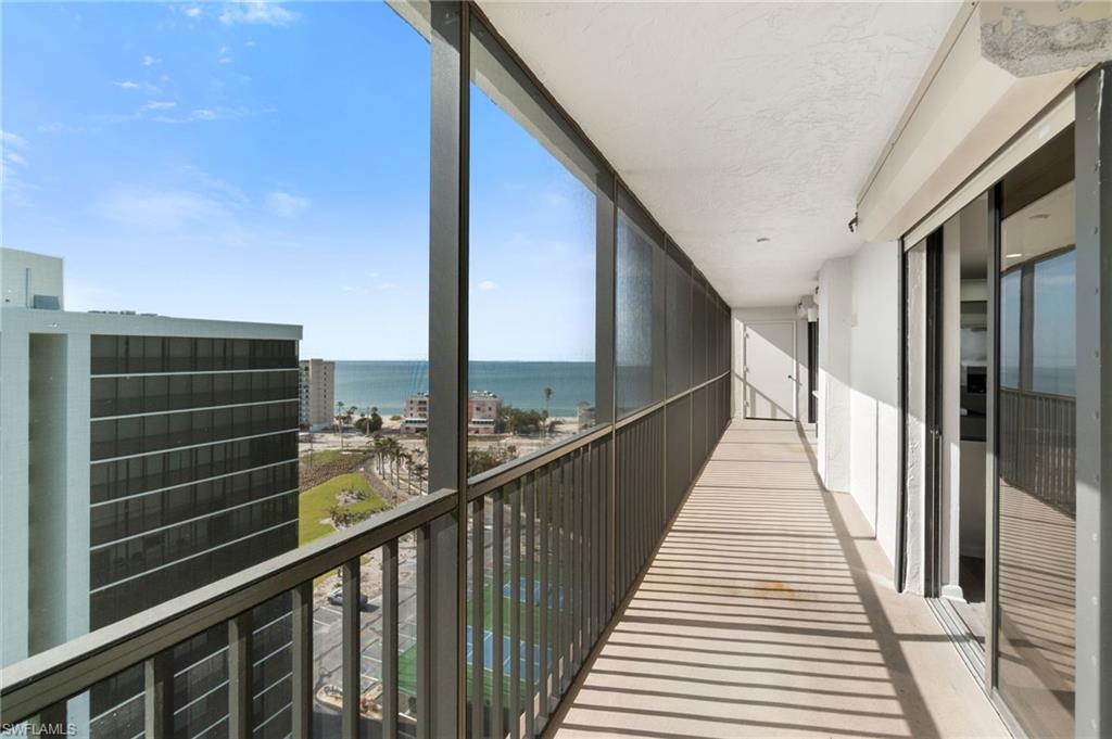 Balcony with a sunroom and a water view
