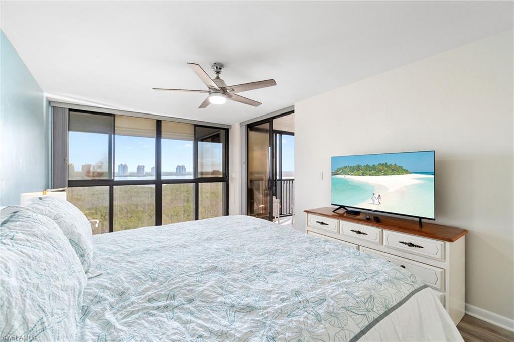 Bedroom with floor to ceiling windows, ceiling fan, access to outside, and light wood-type flooring
