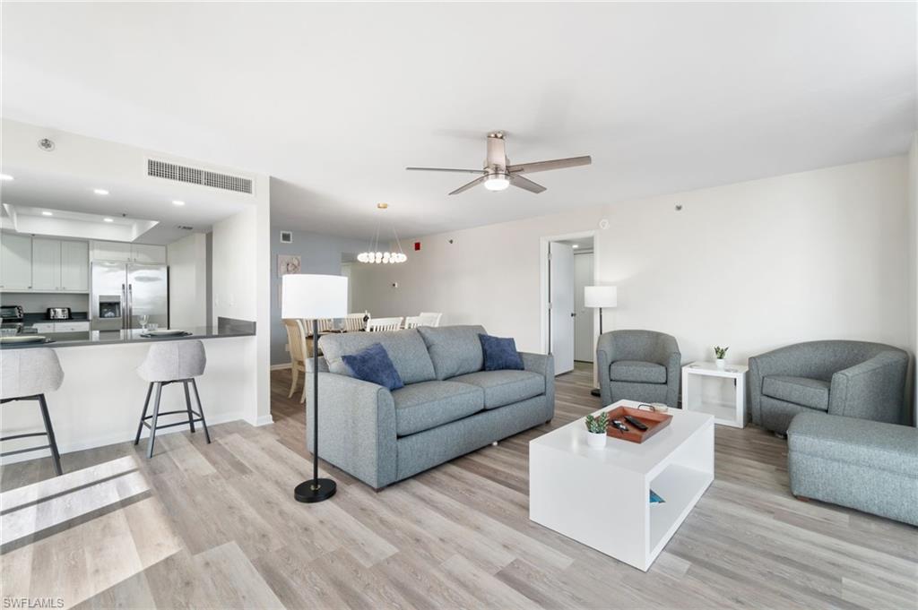 Living area with light wood-style floors, recessed lighting, and ceiling fan