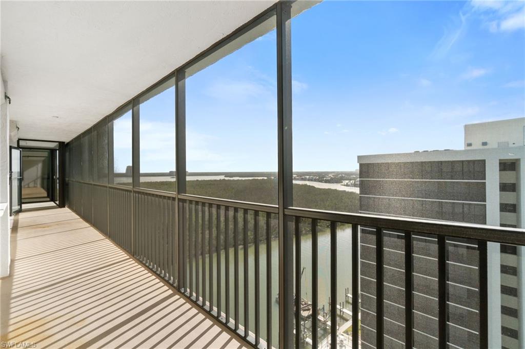 Balcony featuring a water view and a sunroom