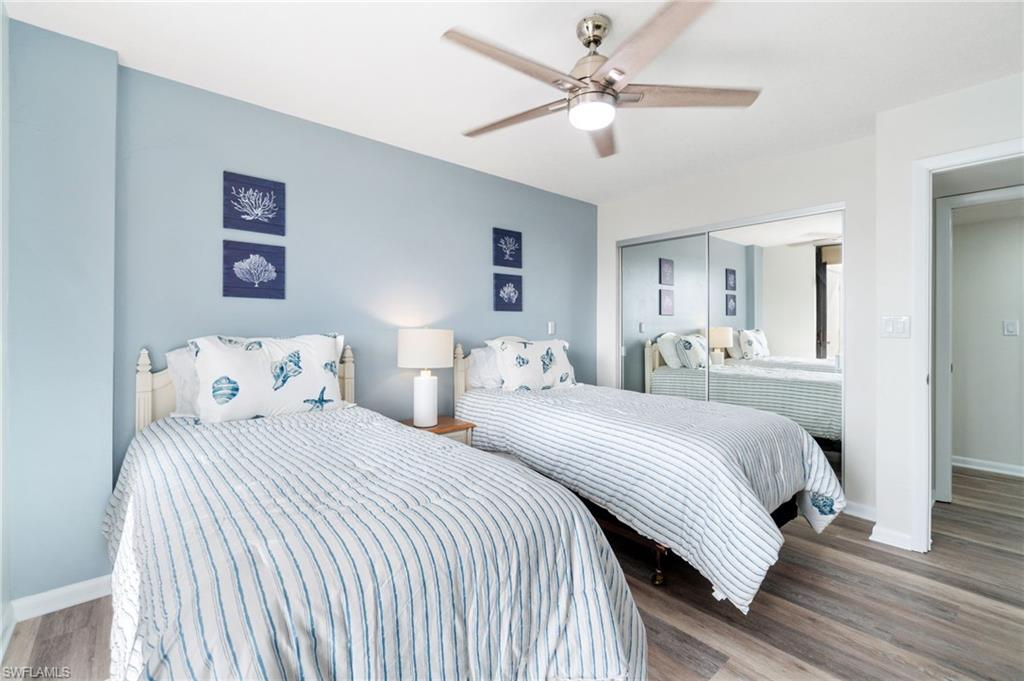 Bedroom with wood finished floors, ceiling fan, and a closet