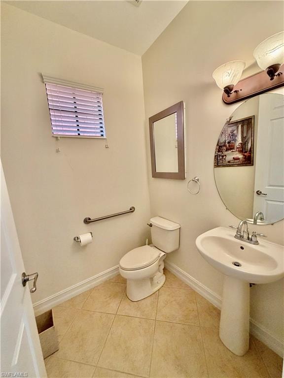Bathroom with baseboards and light tile patterned flooring