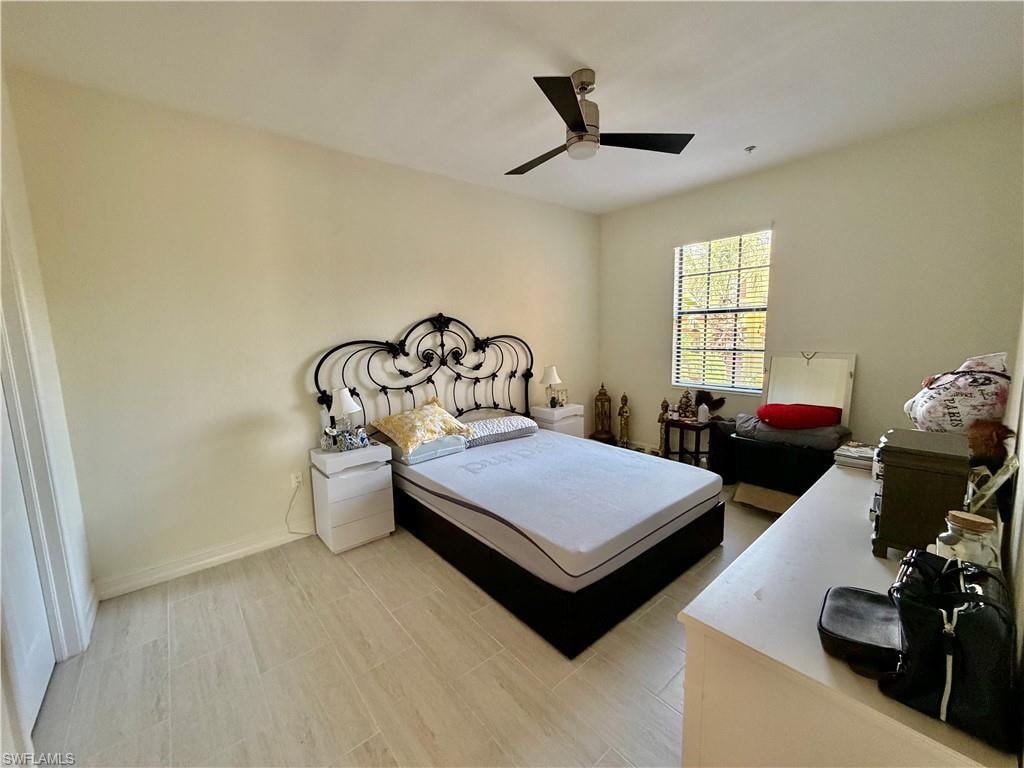 Bedroom featuring a ceiling fan and baseboards