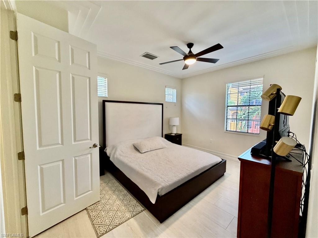 Bedroom featuring a ceiling fan and crown molding