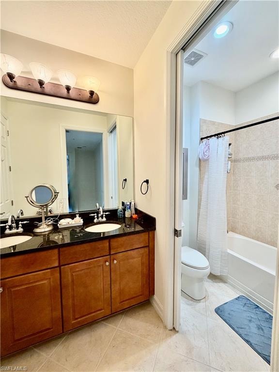 Full bath featuring double vanity, shower / tub combo, and light tile patterned floors