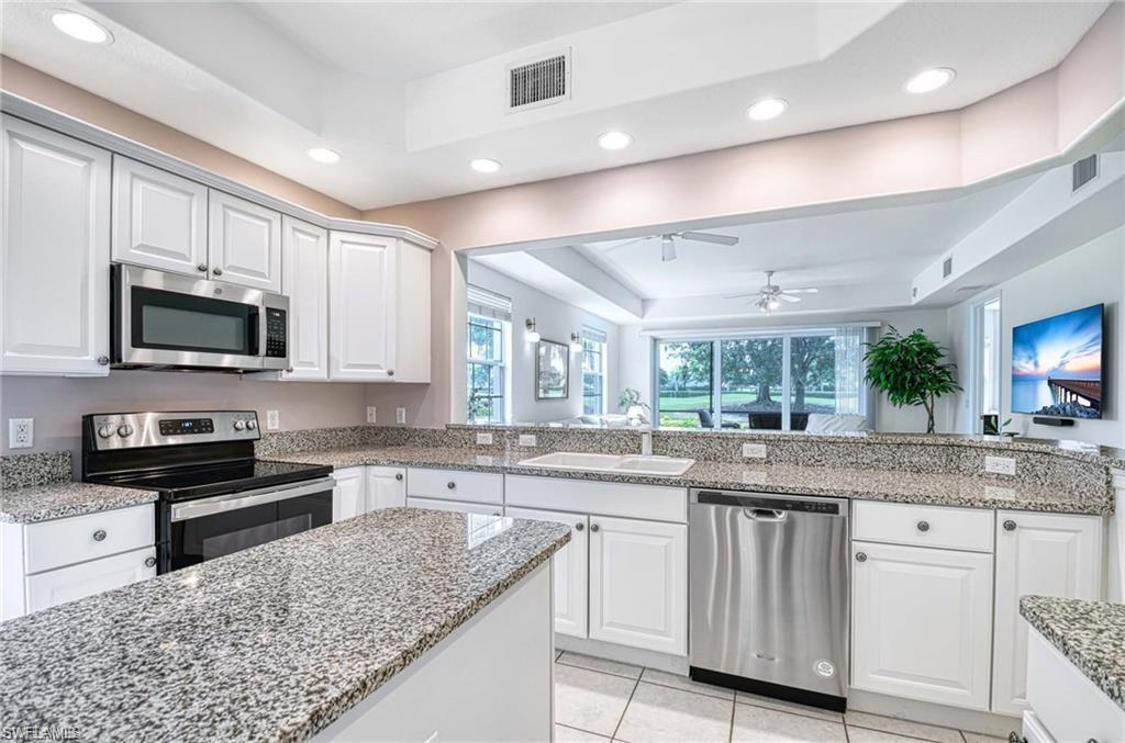 Kitchen with granite counters open to living area