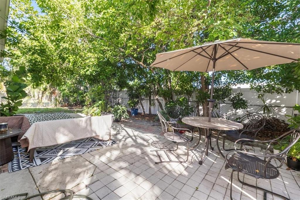 Fenced backyard featuring a patio area and outdoor dining area