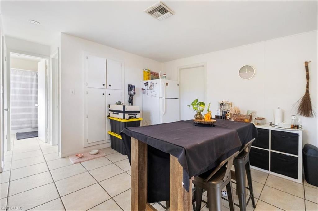 Dining space featuring light tile patterned flooring