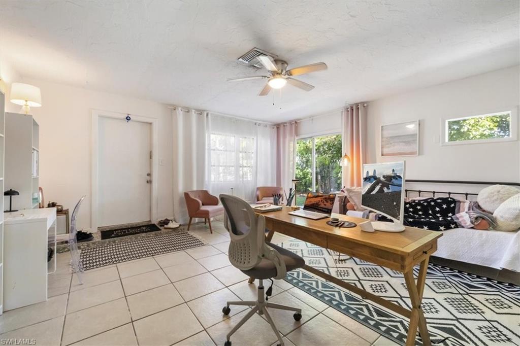 Home office featuring ceiling fan and light tile patterned flooring
