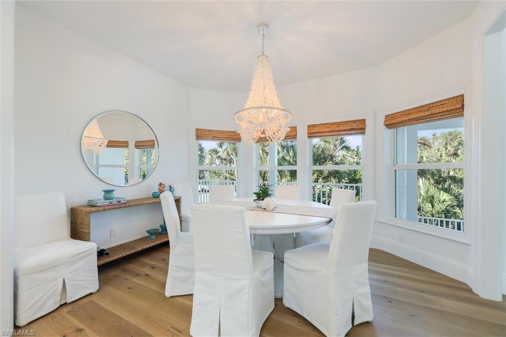 Dining space with hardwood / wood-style flooring and an inviting chandelier