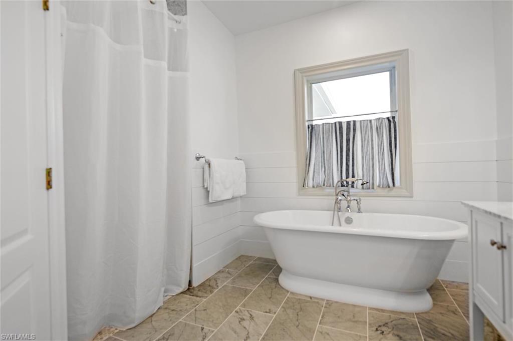 Bathroom with vanity and a bath