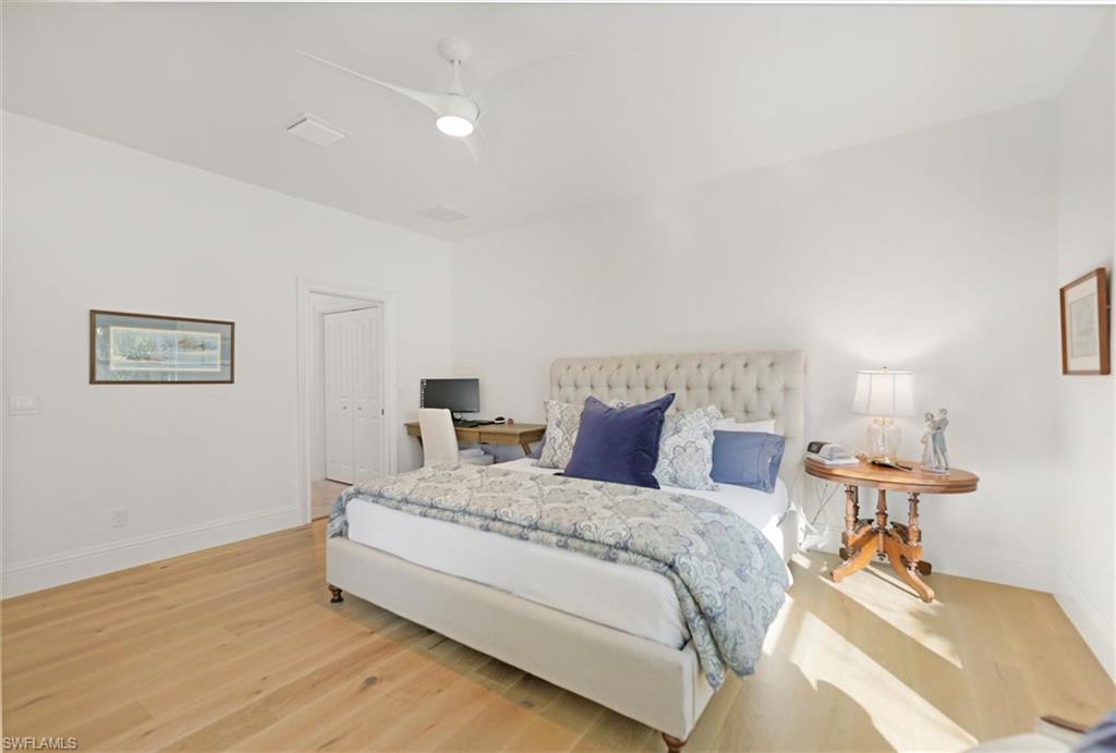 Bedroom with ceiling fan, hardwood / wood-style floors, and a closet