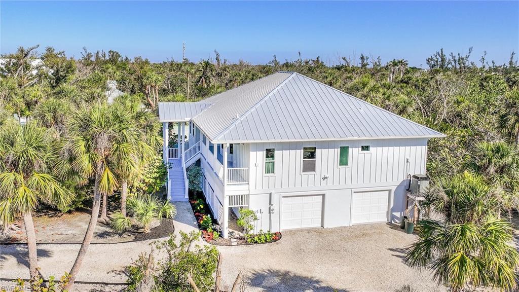 Sanibel Island Beach Home with Deeded Beach Access along a private path and a dock for kayaking or paddle boarding located on Shearwater.
