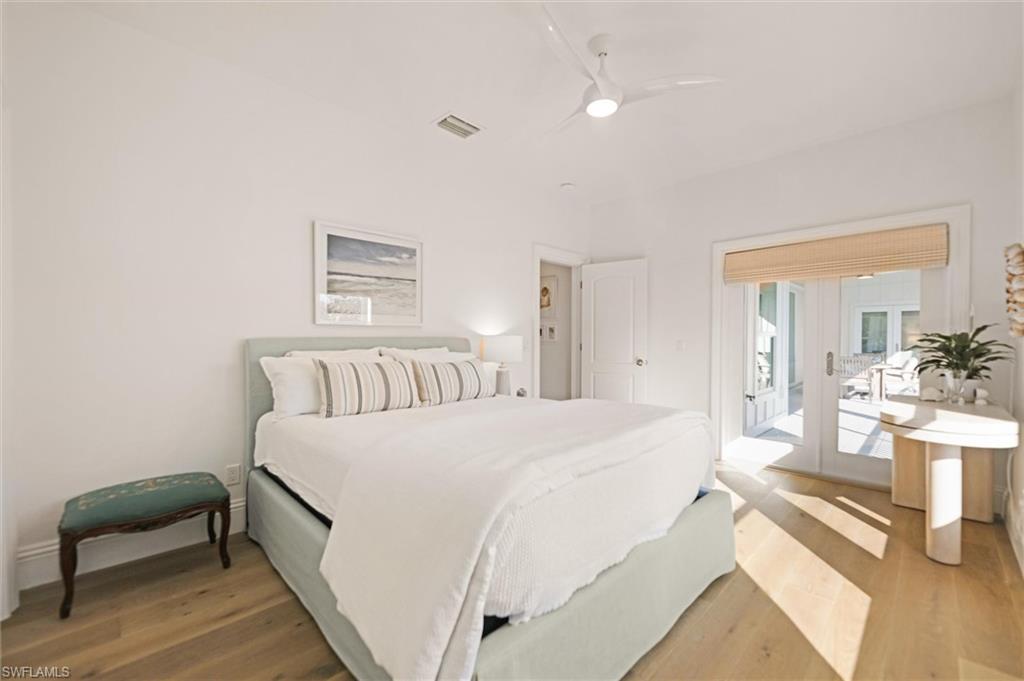 Bedroom with french door to exterior, ceiling fan, and engineered hardwood flooring