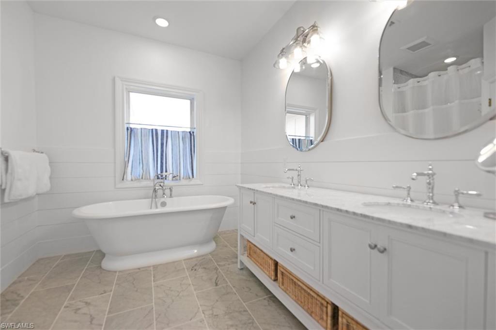 Bathroom with vanity and a tub to relax in