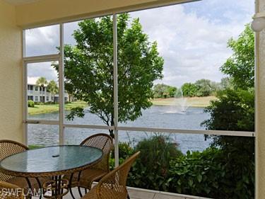 Sunroom / solarium with a water view