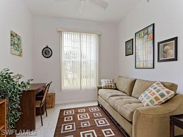 Living area with light tile patterned floors and a ceiling fan