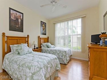 Bedroom with light wood-style floors and a ceiling fan