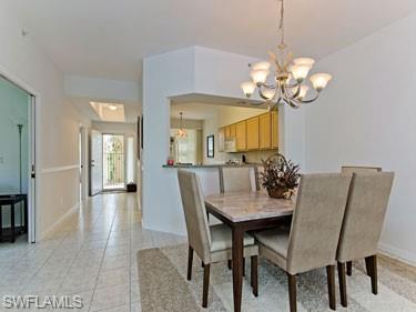 Dining area with a chandelier and light tile patterned floors