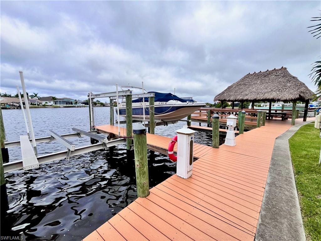 Dock area featuring boat lift and a water view - can be leased with rental