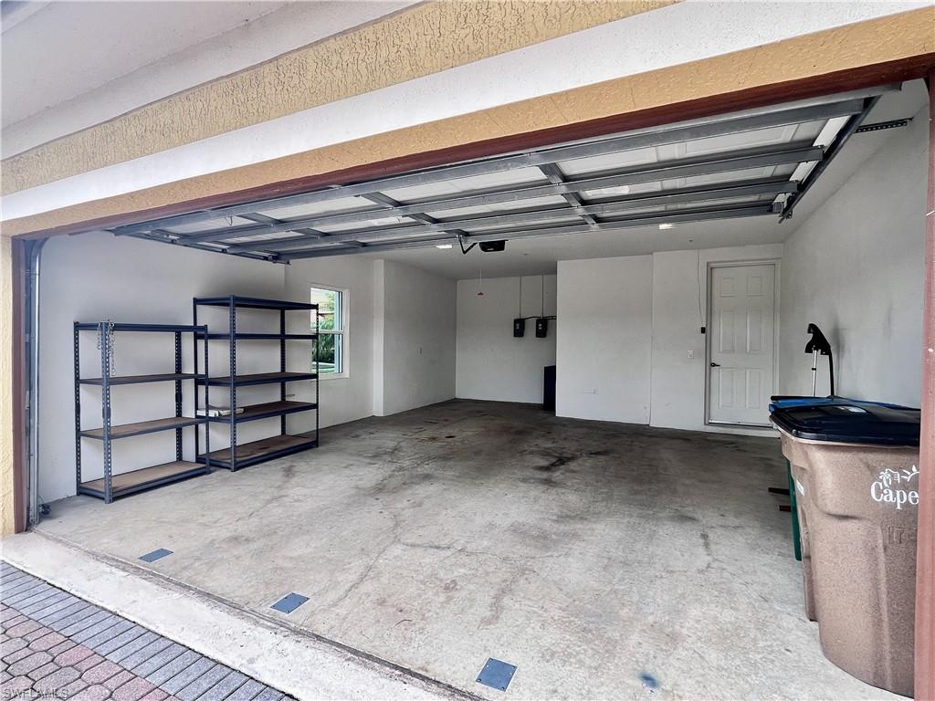 View of 2 car garage with storage