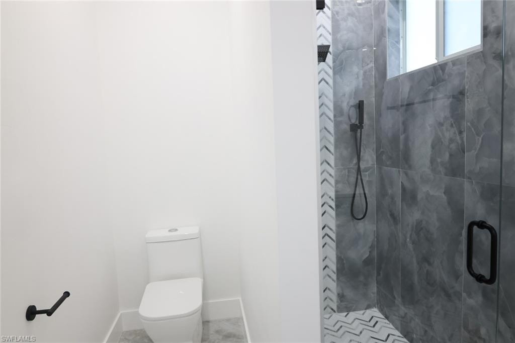 Bathroom featuring a stall shower and toilet