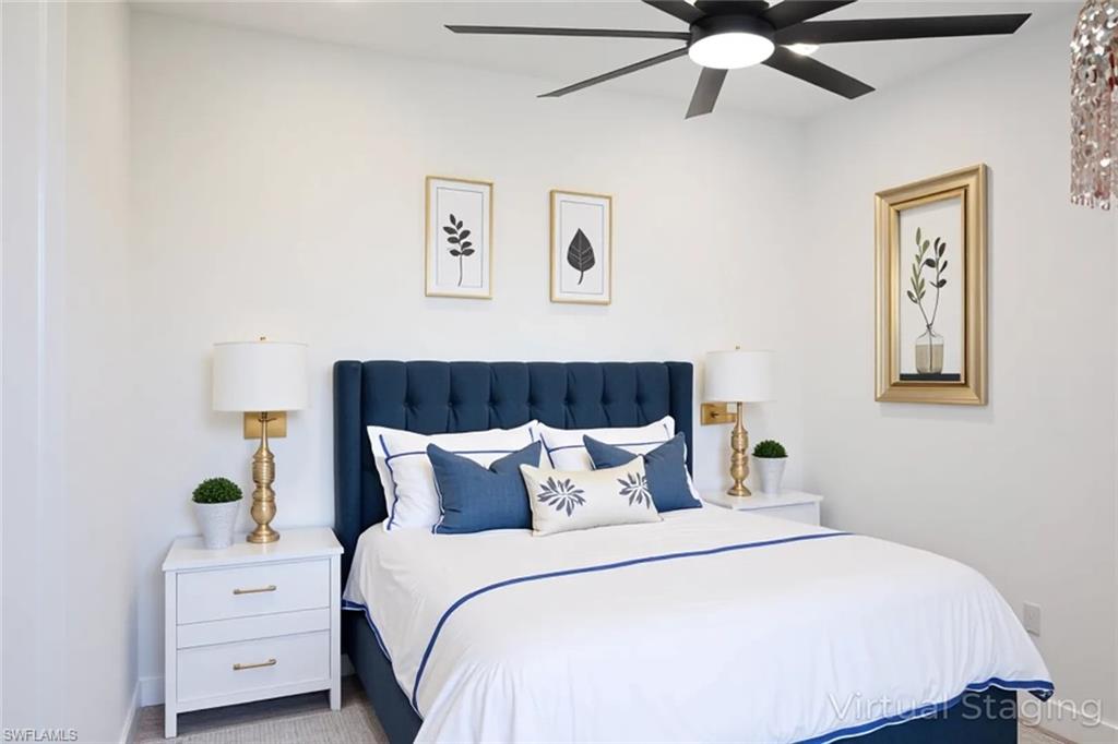 Carpeted bedroom with a ceiling fan and baseboards