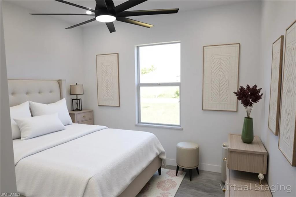 Bedroom with wood finished floors and ceiling fan