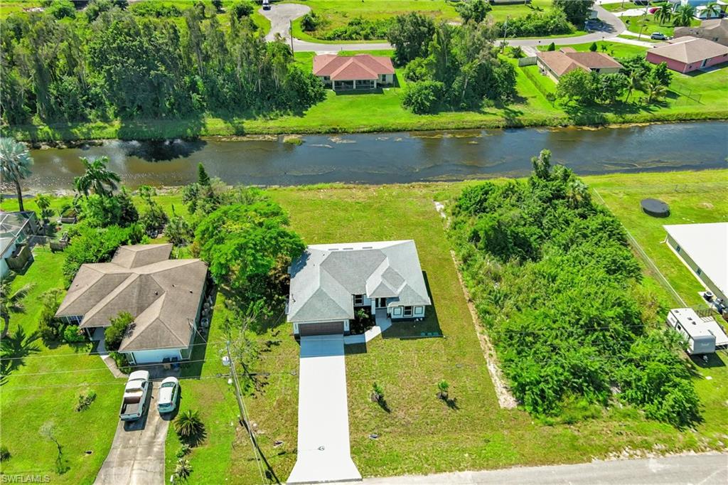 Aerial perspective of suburban area with a large body of water